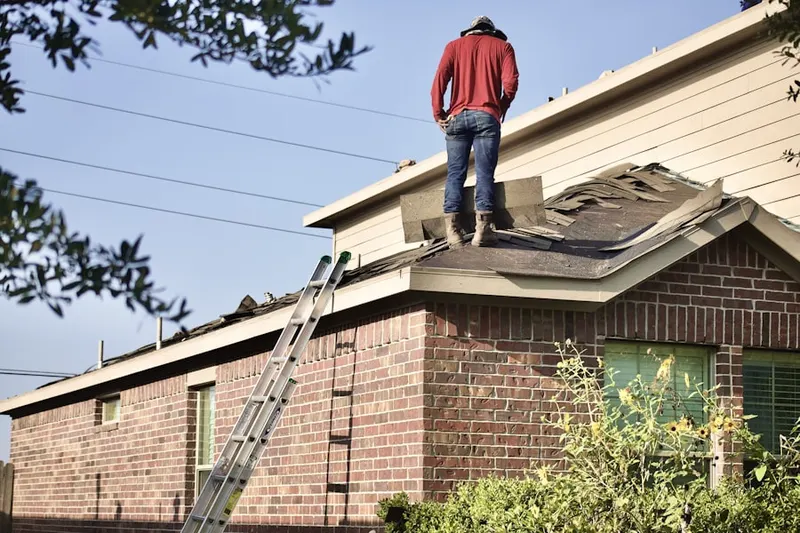 Professional roofer working on a residential roof in Martinez